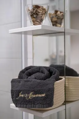 a shelf with a towel and a bowl of nuts at Apartmaji Irma in Moravske Toplice
