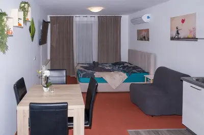 a small living room with a bed and a table at Apartmaji Irma in Moravske Toplice