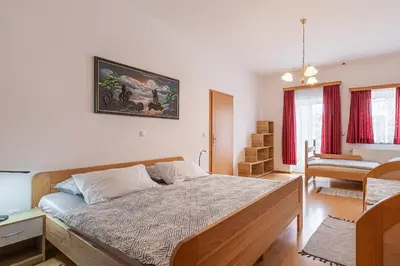 a bedroom with a large bed in a room at Apartments Natura in Adlešiči