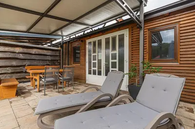 a patio with two chairs and a table and a table at Apartments Natura in Adlešiči