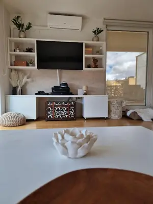 a living room with a tv and a table at Waldorf Apartment in Ljubljana
