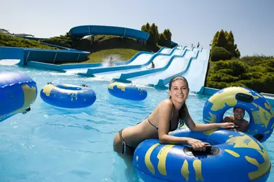 a woman is riding on an inflatable raft in a water park at Holiday home Isabella in Terme Čatež in Čatež ob Savi