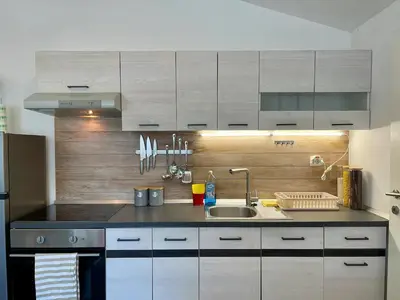 a kitchen with a sink and a counter top at Chic Loft with Open Floor Plan in Spodnja Šiška