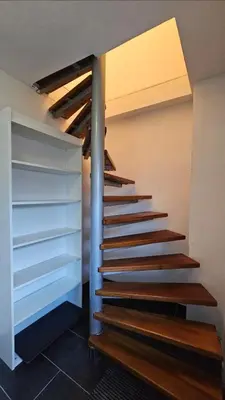 a set of stairs in a room with a ceiling at Chic Loft with Open Floor Plan in Spodnja Šiška