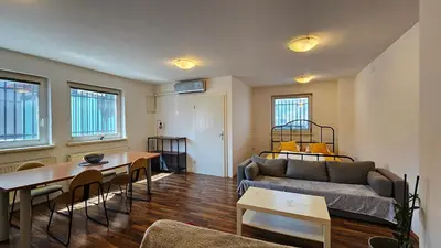 a living room with a couch and a table at Industrial vibe flat in Ljubljana