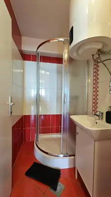a bathroom with a shower and a sink at Industrial vibe flat in Ljubljana