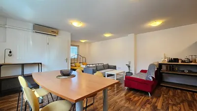 a living room with a table and a couch at Industrial vibe flat in Ljubljana