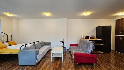 a living room with a couch and a bed at Industrial vibe flat in Ljubljana