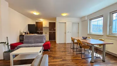 a living room with a couch and a table at Industrial vibe flat in Ljubljana