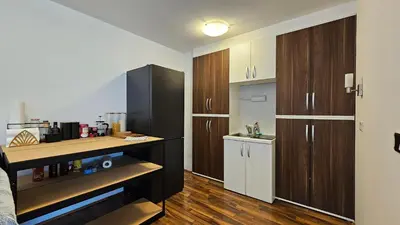 a kitchen with wooden cabinets and a counter top at Industrial vibe flat in Ljubljana