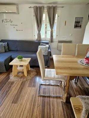 a living room with a blue couch and a table at Madeira House - Terme Čatež in Čatež ob Savi