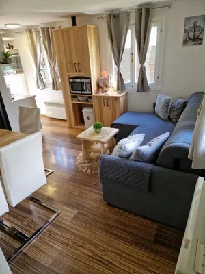 a living room with a couch and a table at Madeira House - Terme Čatež in Čatež ob Savi