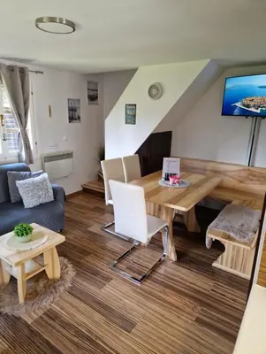 a living room with a table and a couch at Madeira House - Terme Čatež in Čatež ob Savi