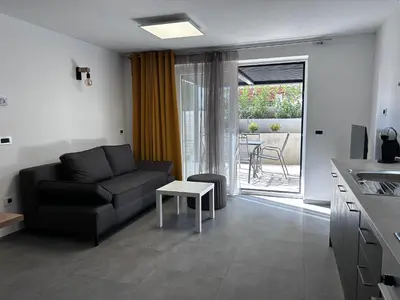 a living room with a couch and a table at Apartment Angelina in Cerklje na Gorenjskem