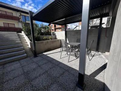 a patio with chairs and a table on a building at Apartment Angelina in Cerklje na Gorenjskem