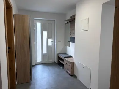 a room with a hallway with a door and a kitchen at Apartment Angelina in Cerklje na Gorenjskem