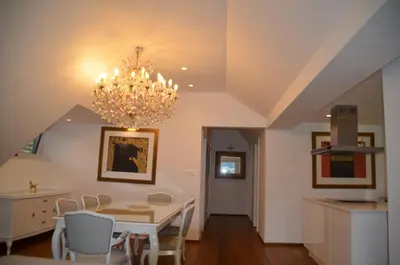 a dining room with a table and a chandelier at Delux apartment at Robida Estate in Dolenjske Toplice