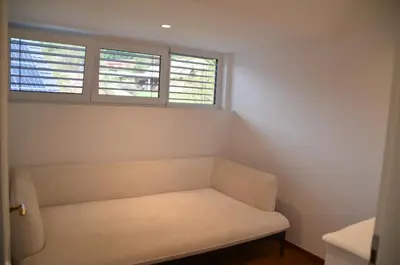 a room with a white couch and two windows at Delux apartment at Robida Estate in Dolenjske Toplice