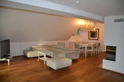 a living room with a couch and a table at Delux apartment at Robida Estate in Dolenjske Toplice