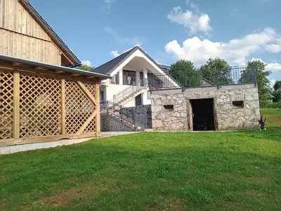 a house with a large yard in front of it at Delux apartment at Robida Estate in Dolenjske Toplice