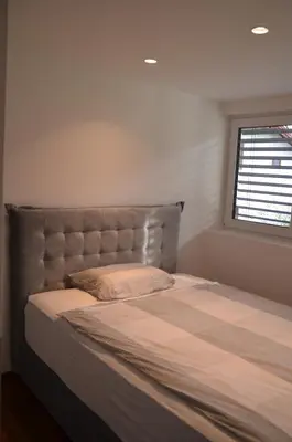 a large bed in a bedroom with a window at Delux apartment at Robida Estate in Dolenjske Toplice