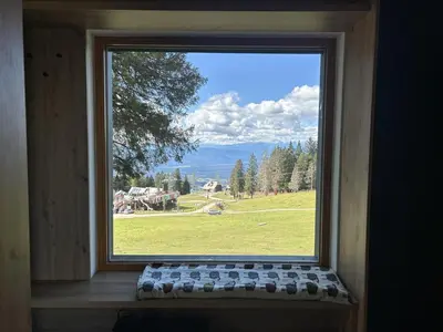 a large window with a view of a field at Panorama Krvavec Ski-in, Ski-out in Cerklje na Gorenjskem