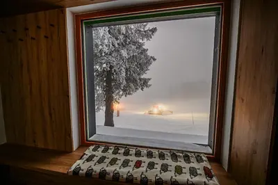 a window with a bunch of keyboards in a room at Panorama Krvavec Ski-in, Ski-out in Cerklje na Gorenjskem