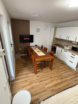 a kitchen and dining room with a table and chairs at La Hiška Čatež with Tickets - each guest gets 2 entries per day in Čatež ob Savi