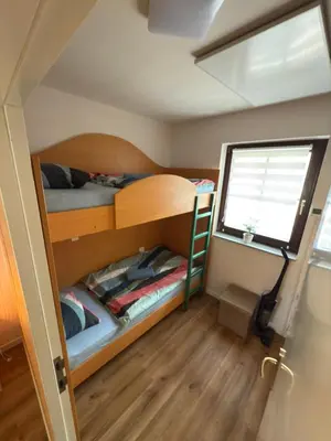 a small room with two bunk beds and a window at La Hiška Čatež with Tickets - each guest gets 2 entries per day in Čatež ob Savi