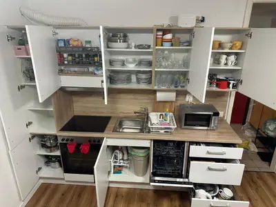 a kitchen with white cabinets and a sink at La Hiška Čatež with Tickets - each guest gets 2 entries per day in Čatež ob Savi