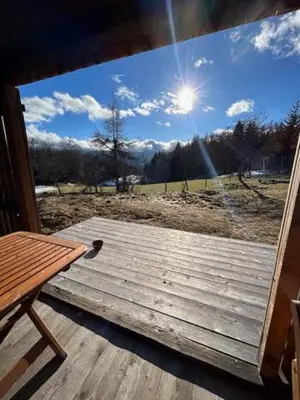 a window of a porch with a view of a field at Gorjuška Rozamunda in Bohinjska Bistrica