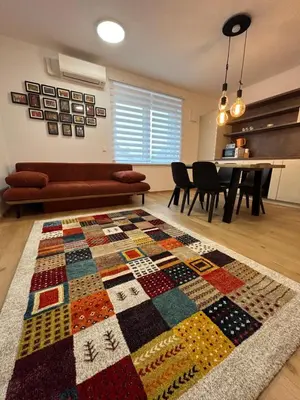 a living room with a quilt on the floor at CASA BOX APARTMENT Free garage in Maribor