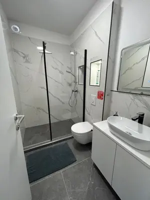 a bathroom with a shower and a toilet and a sink at CASA BOX APARTMENT Free garage in Maribor