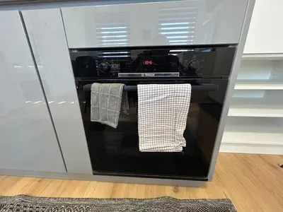 a black oven with two towels hanging in it at CASA BOX APARTMENT Free garage in Maribor