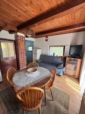 a living room with a table and chairs and a couch at Chalet SS Pohorje in Pohorje