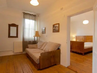 a living room with a couch and a bed at The old Village Villa At 2 Geese with Pool in Pišece
