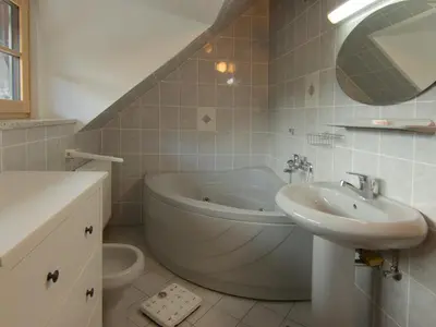 a bathroom with a bath tub and a sink at The old Village Villa At 2 Geese with Pool in Pišece