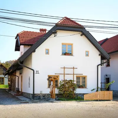 a white house with a red roof at Pri Štefacovih - Authentic house in Grahovo