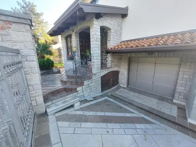 a house with a gate and a garage at Apartma MILA in Šempas