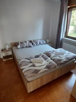 a large bed in a room with a window at Apartma MILA in Šempas