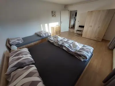 a room with two beds in a room at Apartma MILA in Šempas