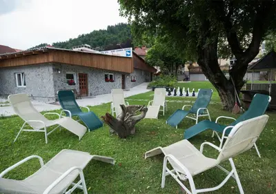 a group of lawn chairs sitting in the grass at Klub Zlata Ribica in Jesenice