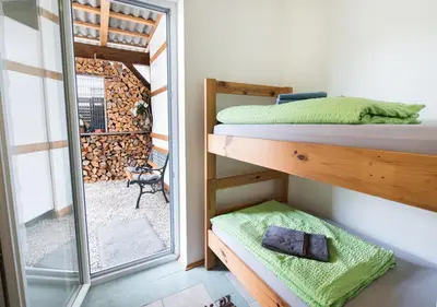 a bedroom with a bunk bed and a mirror at Klub Zlata Ribica in Jesenice