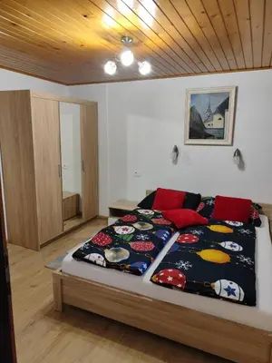 a bedroom with a bed with a colorful blanket on it at Apartment Stefka in Kranjska Gora