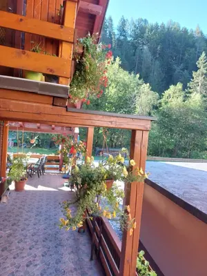 a porch with benches and flowers on a building at Apartment Stefka in Kranjska Gora