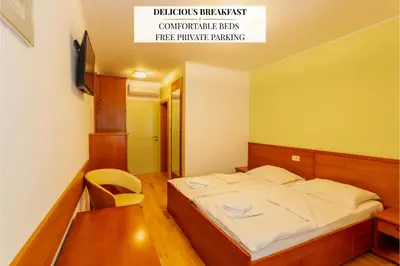 a small bedroom with a bed and a desk at Sobe in apartmaji Triglav - Gostinstvo Tomex in Ilirska Bistrica
