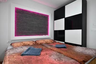 a bedroom with a large bed with a pink window at CASA BOX PREMIUM free garage in Maribor
