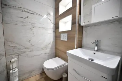 a bathroom with a white sink and a toilet at CASA BOX PREMIUM free garage in Maribor