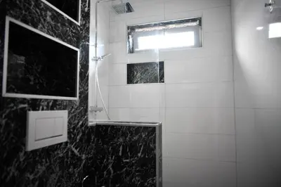a black and white bathroom with a window and a shower at CASA BOX PREMIUM free garage in Maribor