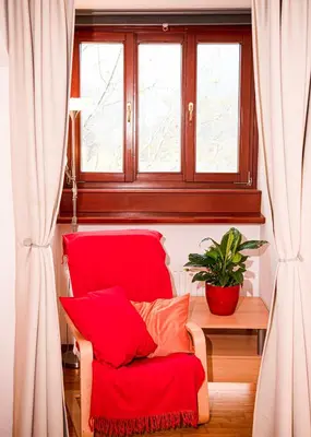 a red chair in a room with a window at Heart Bled in Bled